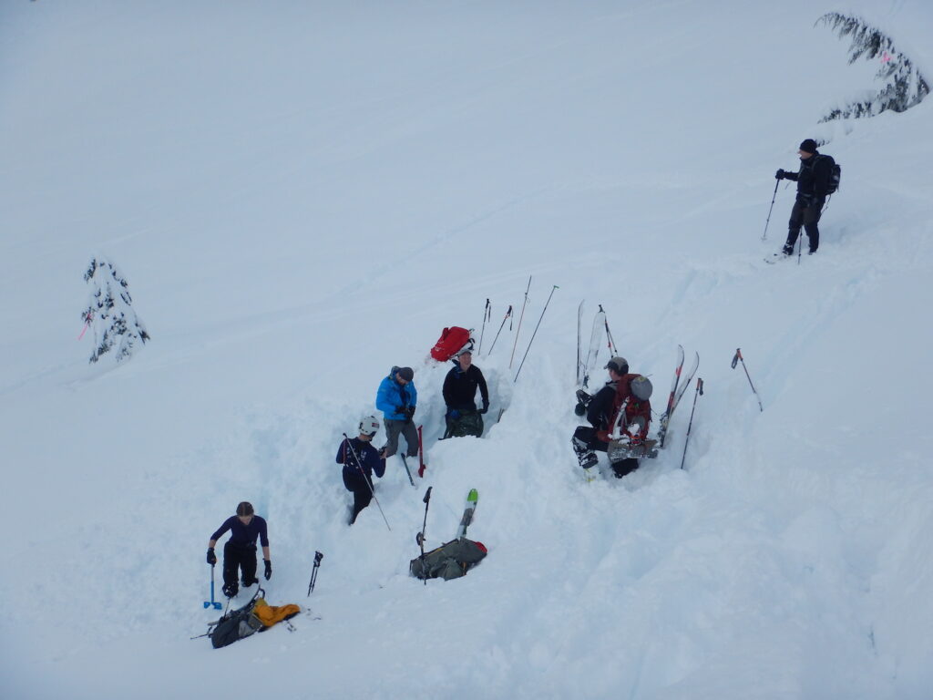 Search teams digging for the 3rd buried beacon and Scott waiting nearby for his acting debut as a broken back injury