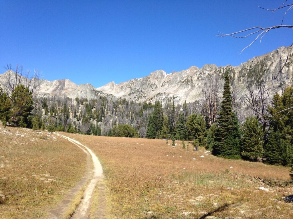 The trail winding through a basin with spectacular surrounding mountains