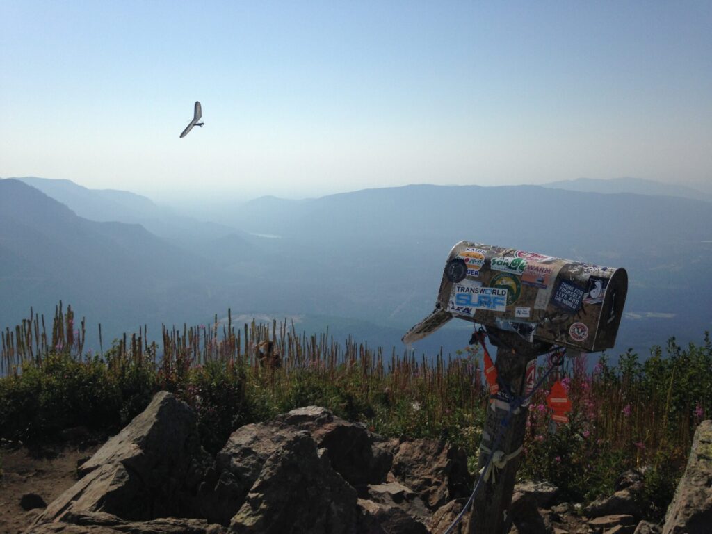 A hang glider making laps over the Mailbox summit. He sure was having a grand time yelling down at everyone